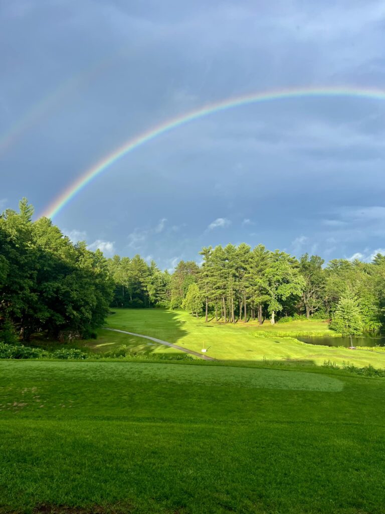 View of the golf course with a rainbow in the sky