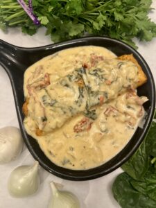 Fish in a pan coated in creamy sauce