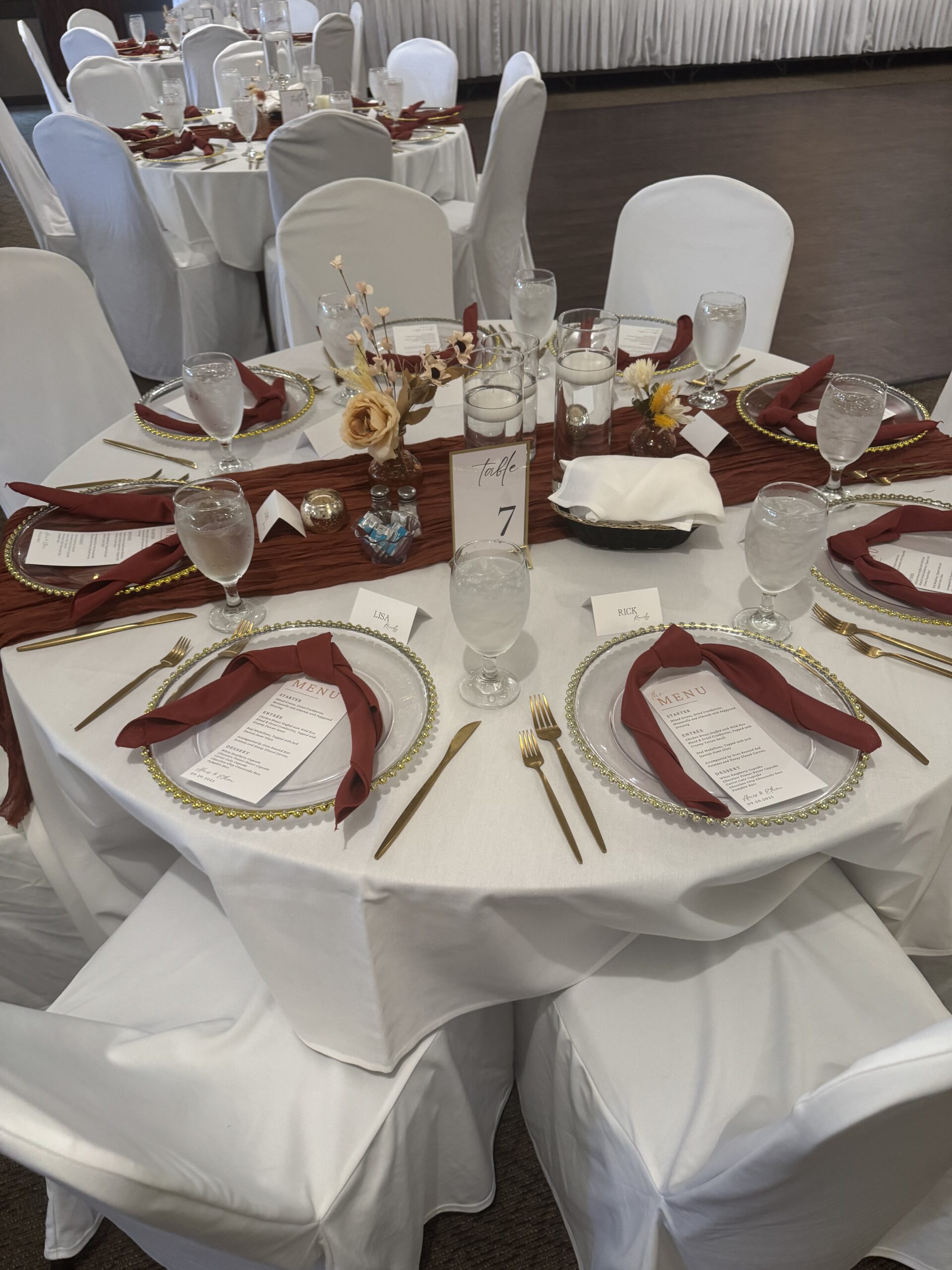Banquet table decorated with plates, glasses, and a sign reading table 7