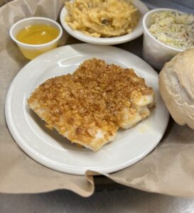 Cornflake crusted haddock with a bread roll and side of coleslaw
