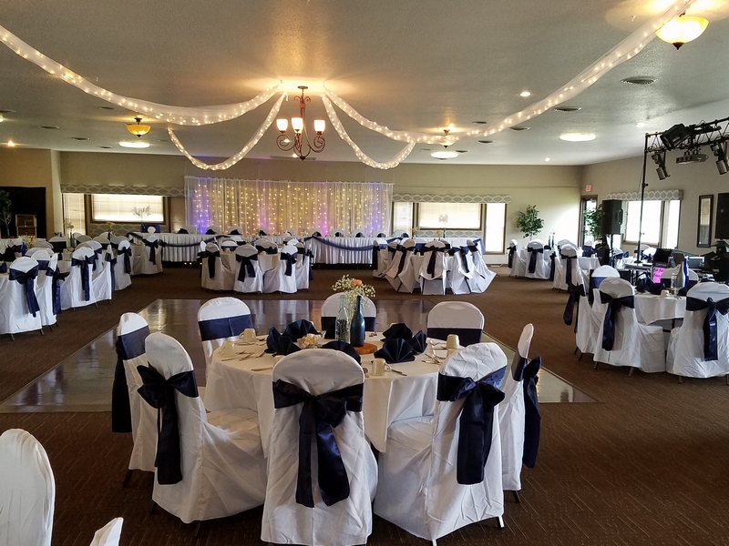 The West Wing banquet room at The Ridges Golf Course, featuring multiple decorated tables and chairs