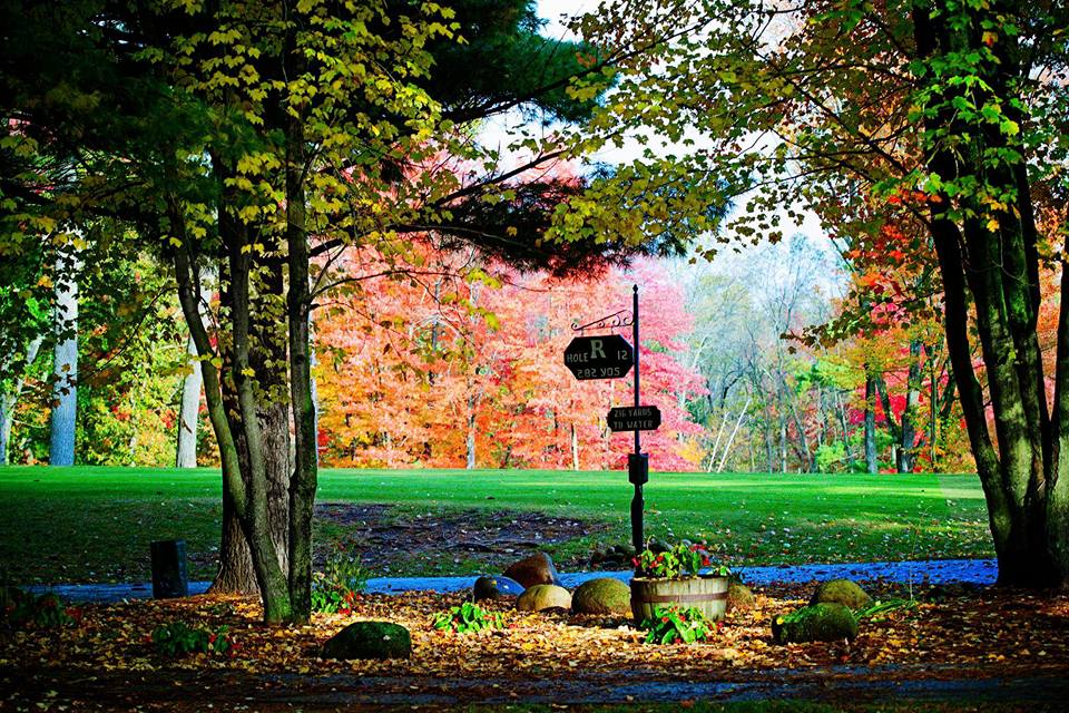 Vibrant autumn trees and a golf sign for hole 12